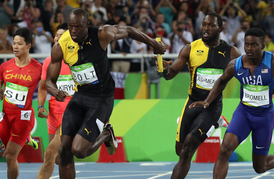 2016 Rio Olympics - Athletics - Final - Men's 4 x 100m Relay Final - Olympic Stadium - Rio de Janeiro, Brazil - 19/08/2016. Nickel Ashmeade (JAM) of Jamaica hands the baton over to teammate Usain Bolt (JAM). REUTERS/Phil Noble FOR EDITORIAL USE ONLY. NOT FOR SALE FOR MARKETING OR ADVERTISING CAMPAIGNS.